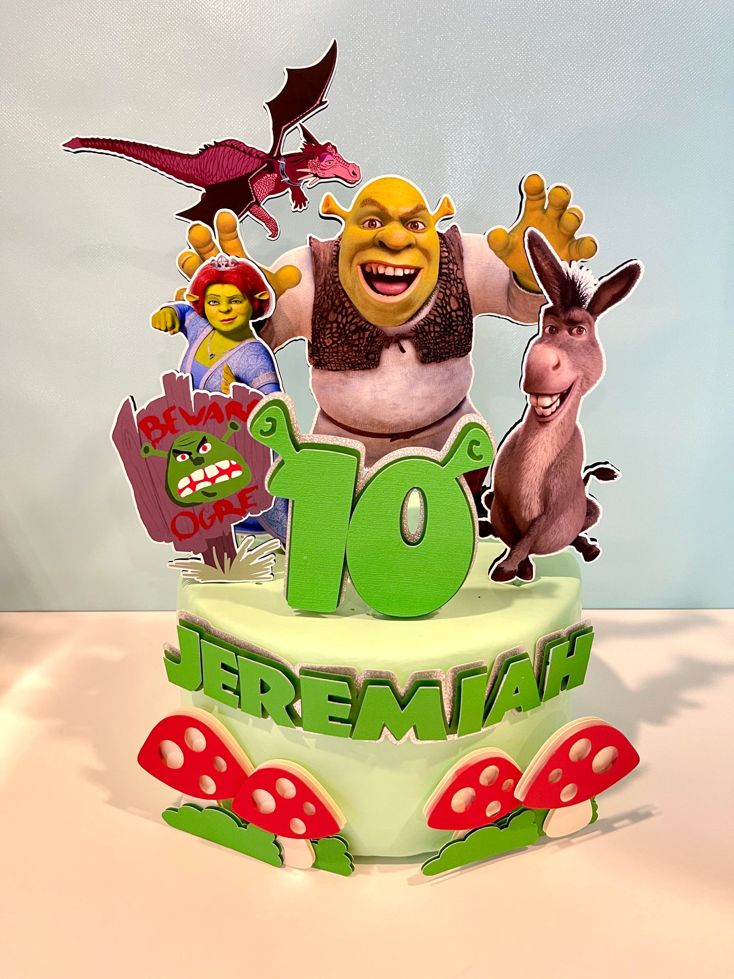 Shrek cake topper featuring Shrek, Donkey, and Fiona characters on a birthday cake