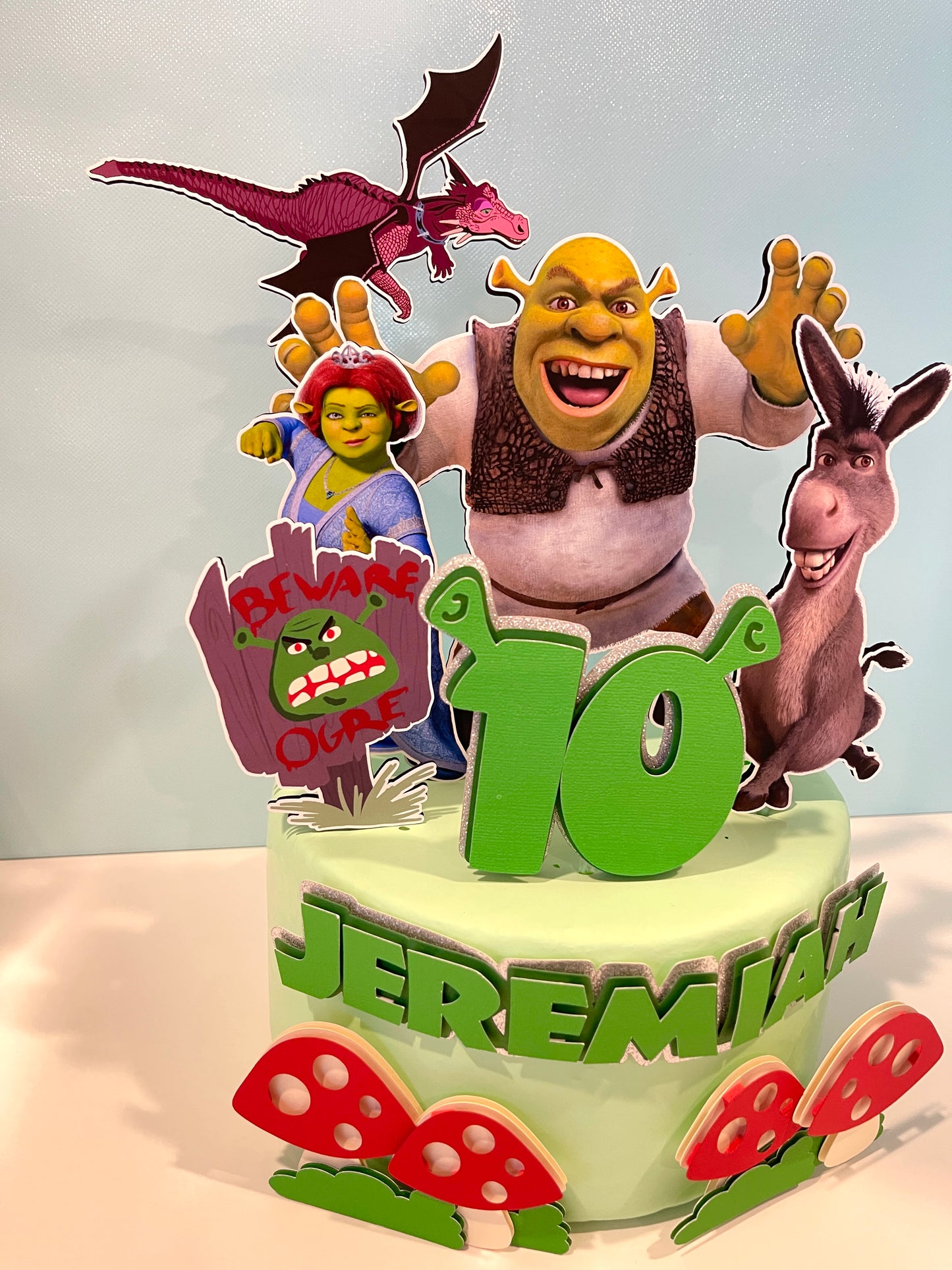 Shrek cake topper featuring Shrek, Donkey, and Fiona characters on a birthday cake