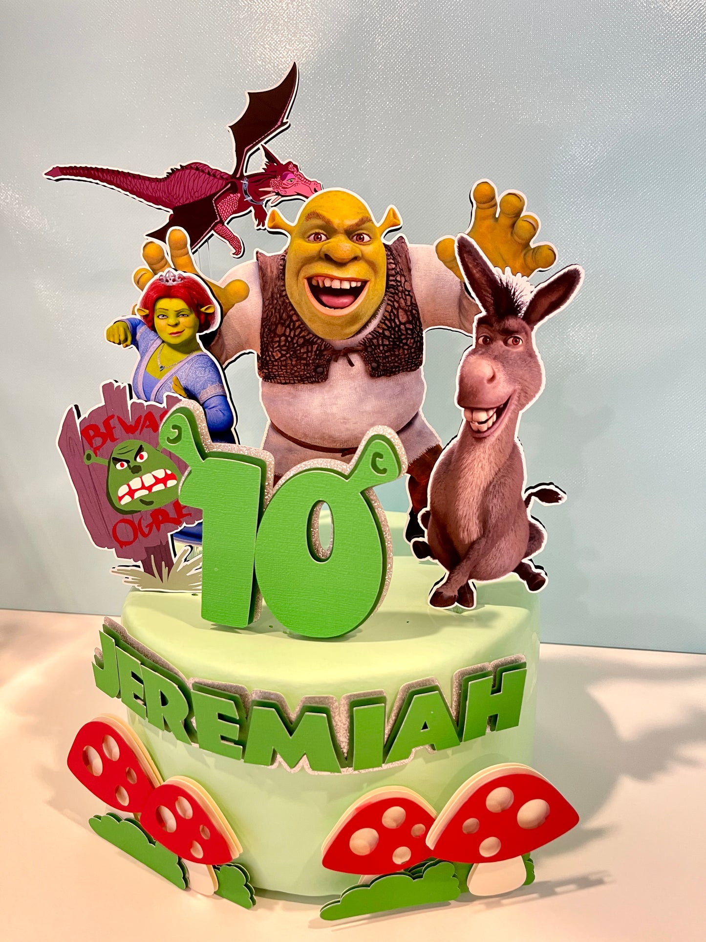 Shrek cake topper featuring Shrek, Donkey, and Fiona characters on a birthday cake